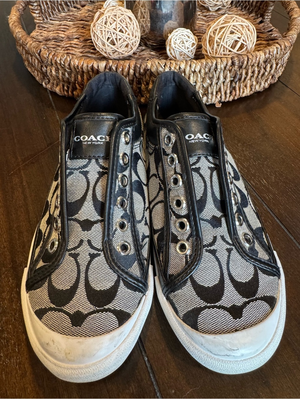 Coach Slip-On Logo Sneakers in Black and White.